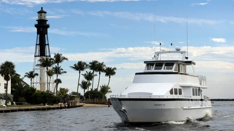 Serenity III cruising beside Hillsboro Lighthouse
